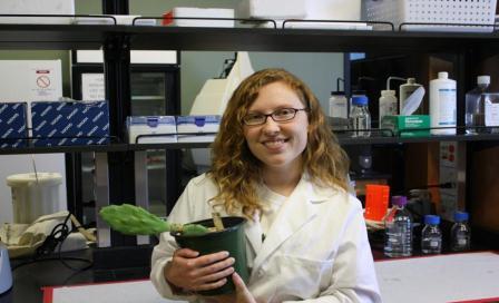 Anastasia Woodard with a cactus in the lab Anastasia Woodard with a cactus in the lab