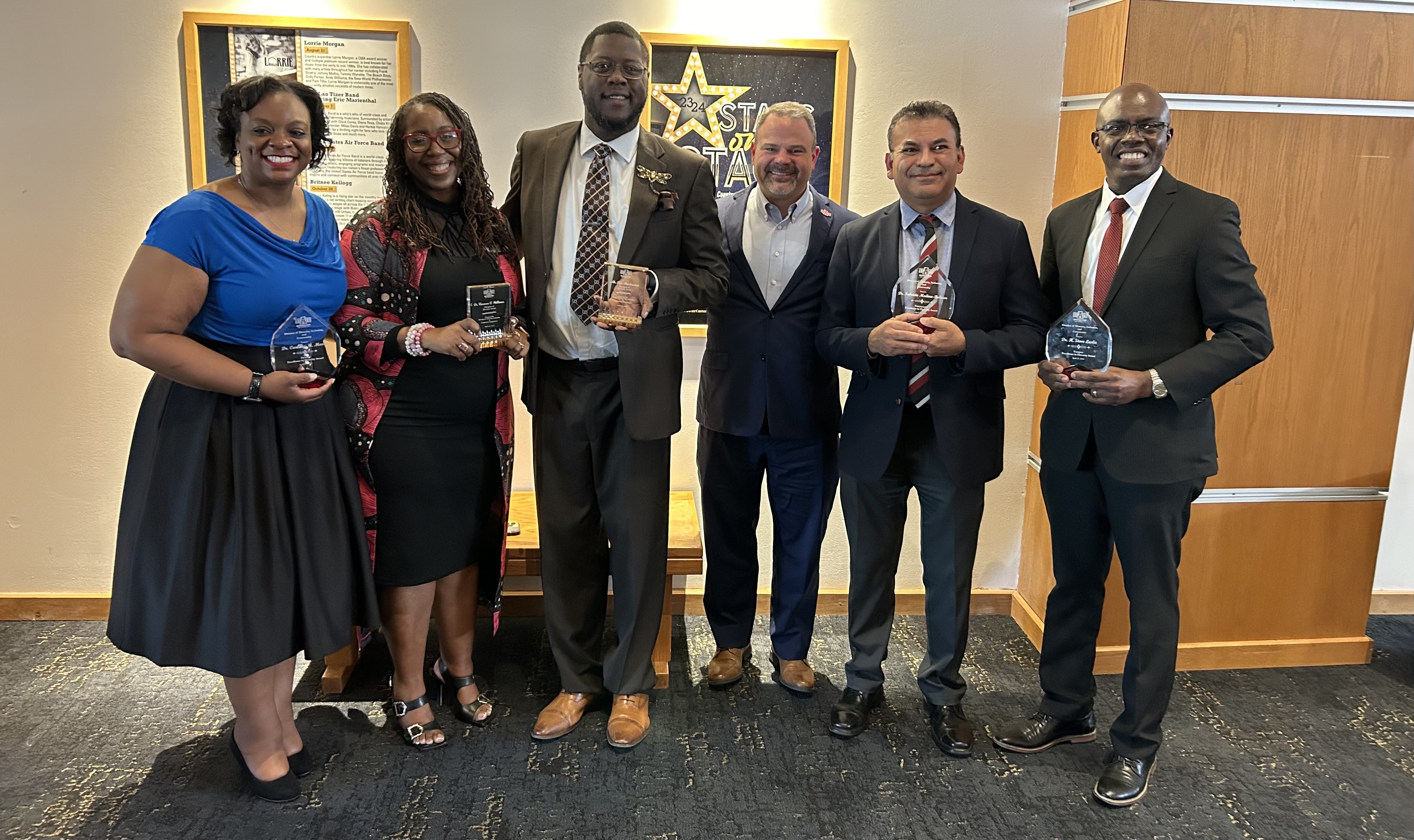 A group Excellence Award winners showing their awards